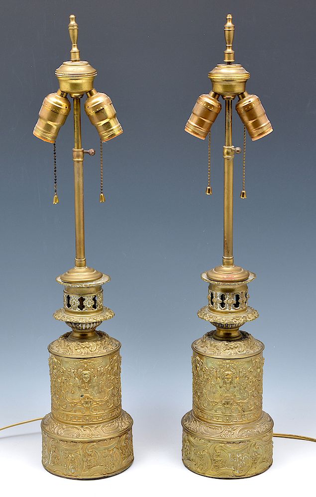 Appraisal: Pair of floral repousse and figural brass lamps Pair of