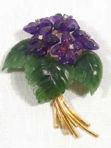 Appraisal: A fine carat gold floral brooch set with carved nephrite