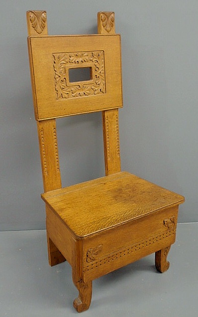 Appraisal: Oak commode chair c with carved back h x w