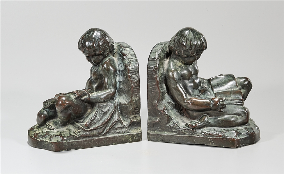 Appraisal: Pair of bronze bookends of seated putti reading x x