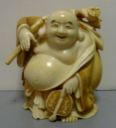 Appraisal: CARVED IVORY FIGURE OF A TRAVELING MAN Carrying a sack