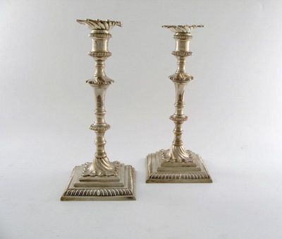 Appraisal: A pair of George III silver cast candlesticks tapering knopped