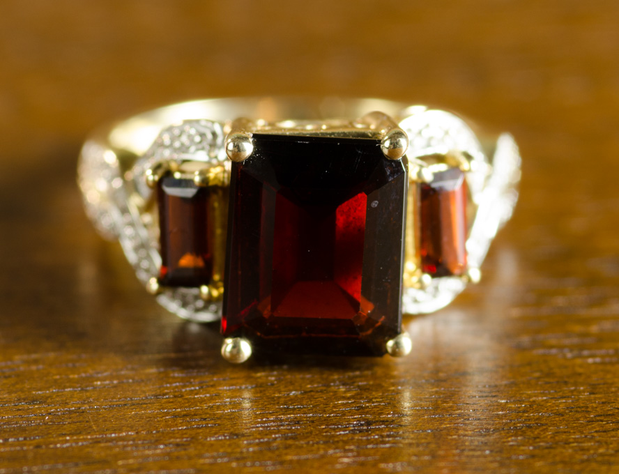 Appraisal: GARNET DIAMOND AND TEN KARAT GOLD RING The yellow and