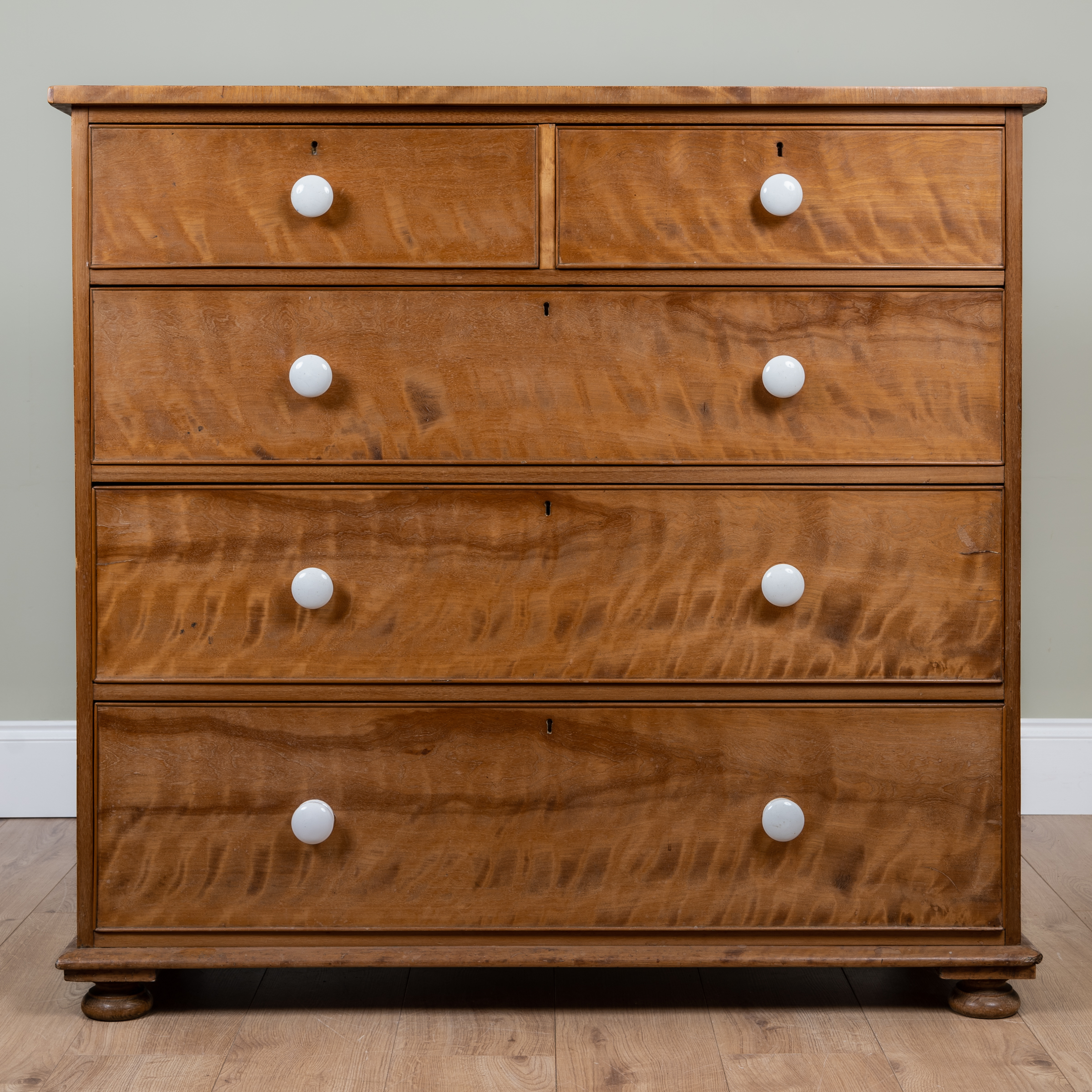 Appraisal: A Victorian satin birch chest of two short and three