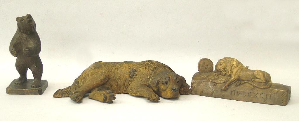 Appraisal: Three carved treen animals recumbent dog wide standing bear high