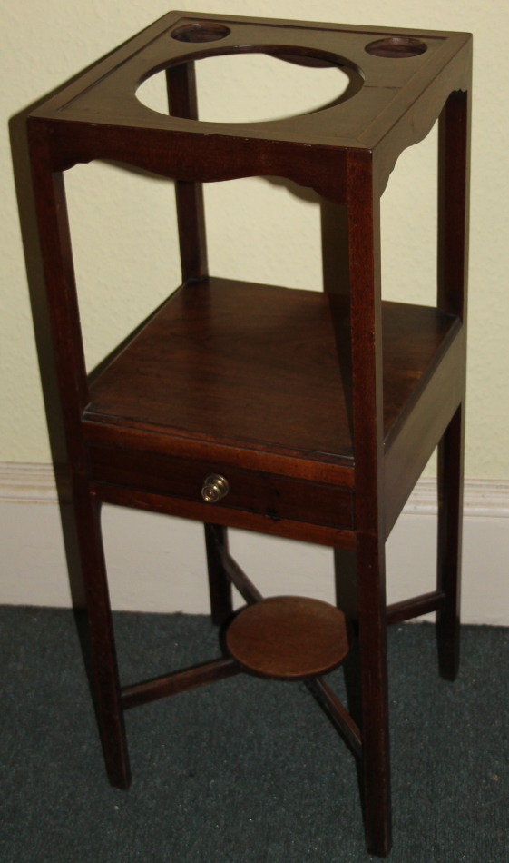 Appraisal: A George III mahogany washstand the square top with recesses