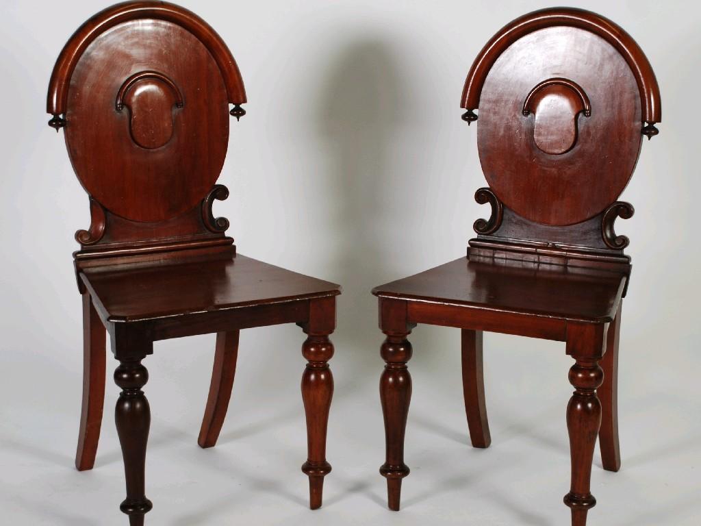 Appraisal: PAIR OF VICTORIAN MAHOGANY HALL CHAIRS with oval panel backs