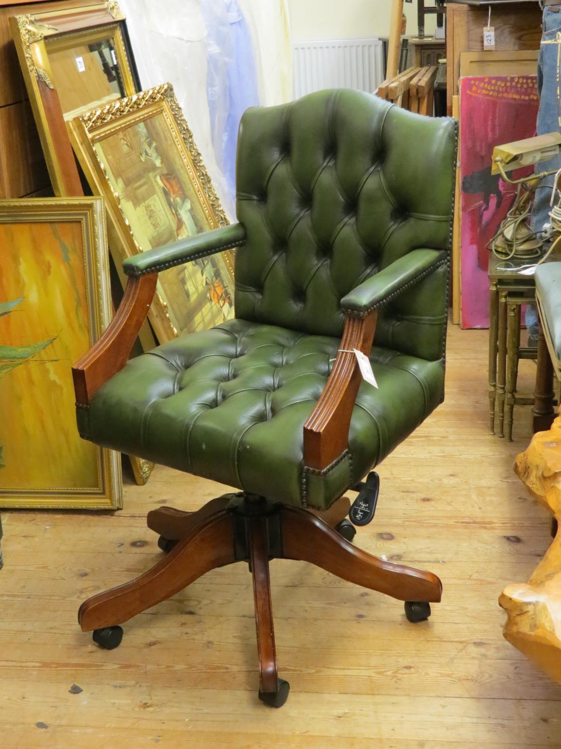 Appraisal: An office armchair upholstered in a buttoned green leather revolving