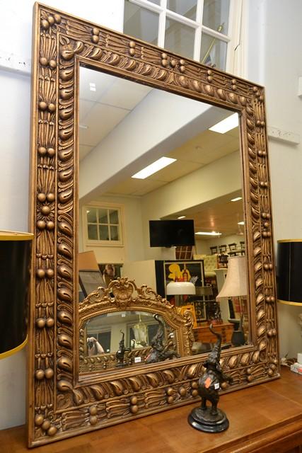 Appraisal: TWO CARVED TIMBER FRAME MIRRORS IN BRONZE FINISH TWO CARVED