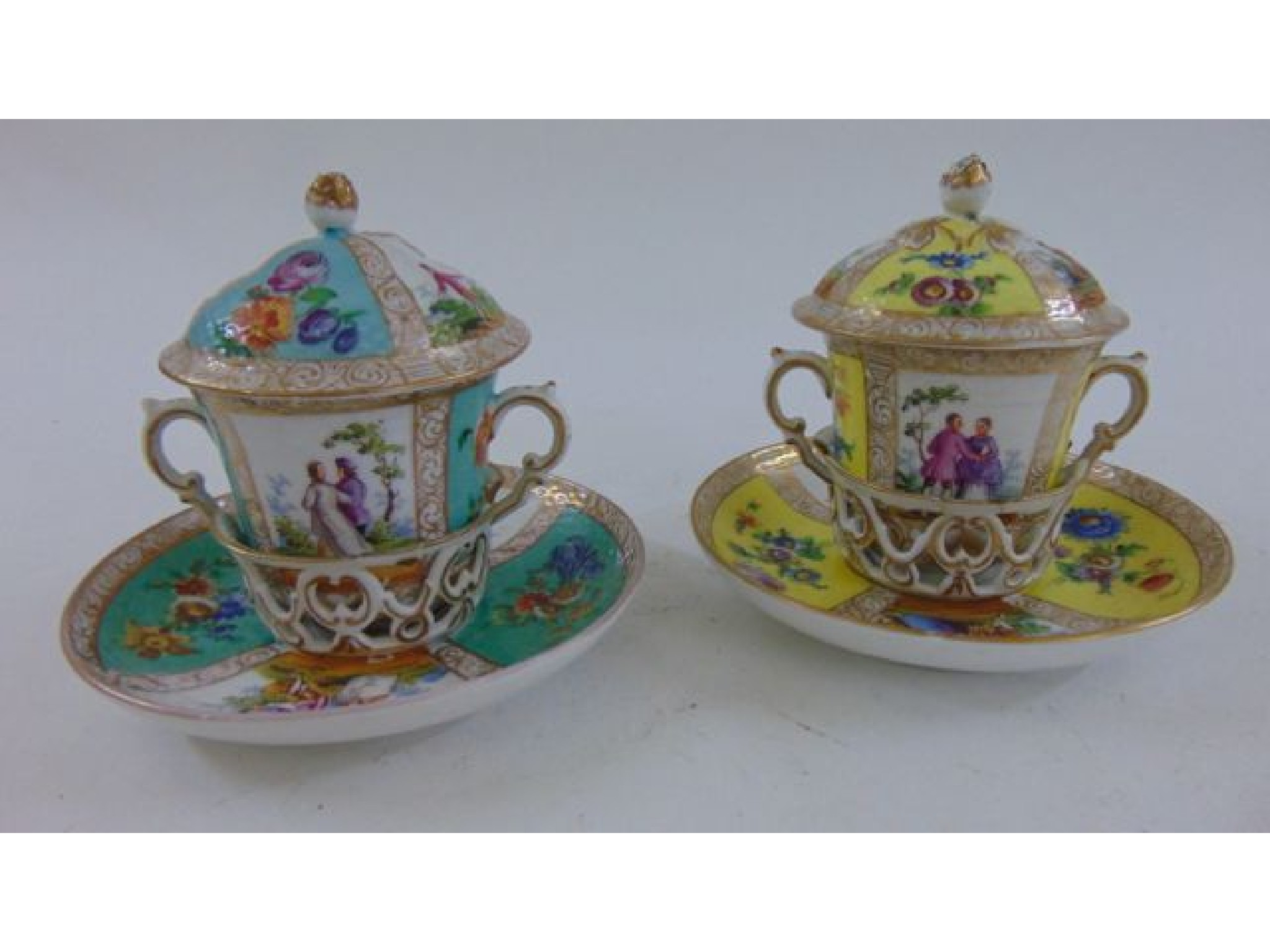 Appraisal: A pair of th century continental porcelain chocolate cups covers