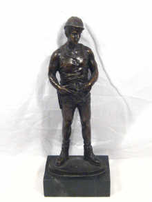 Appraisal: A well patinated bronze figure of a miner on a