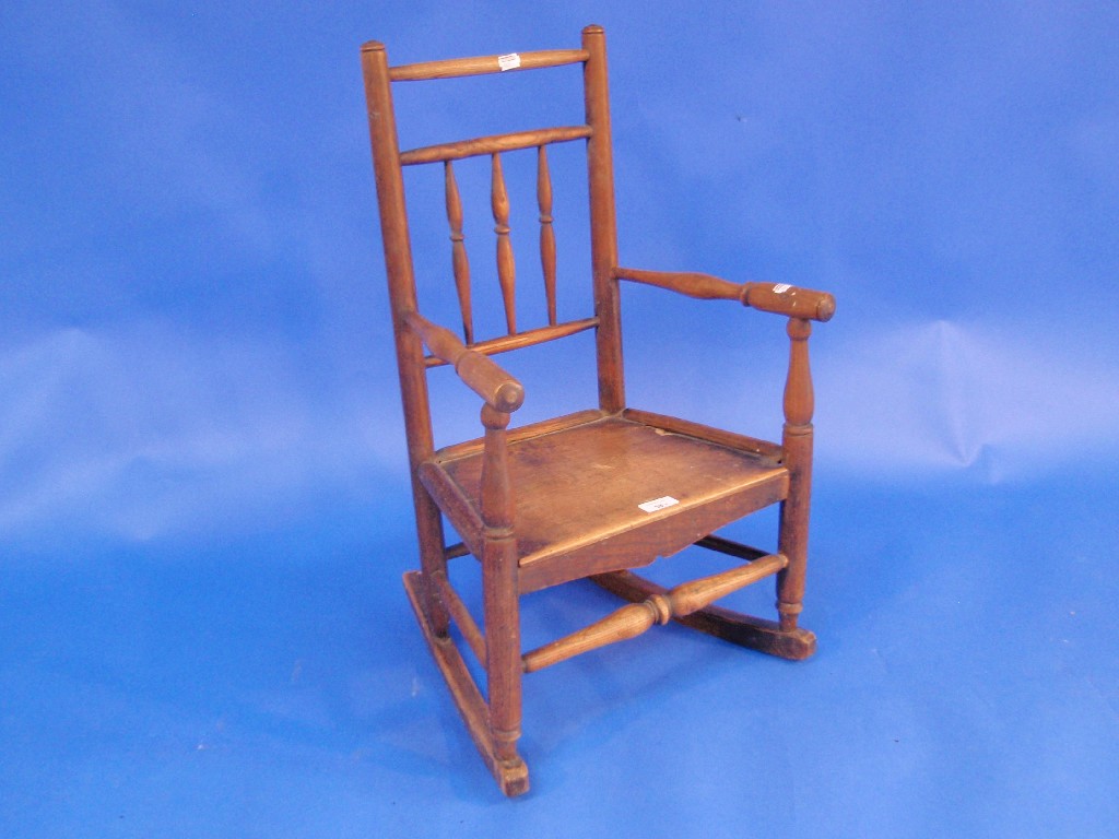 Appraisal: An early th century elm child's rocking chair with spindle