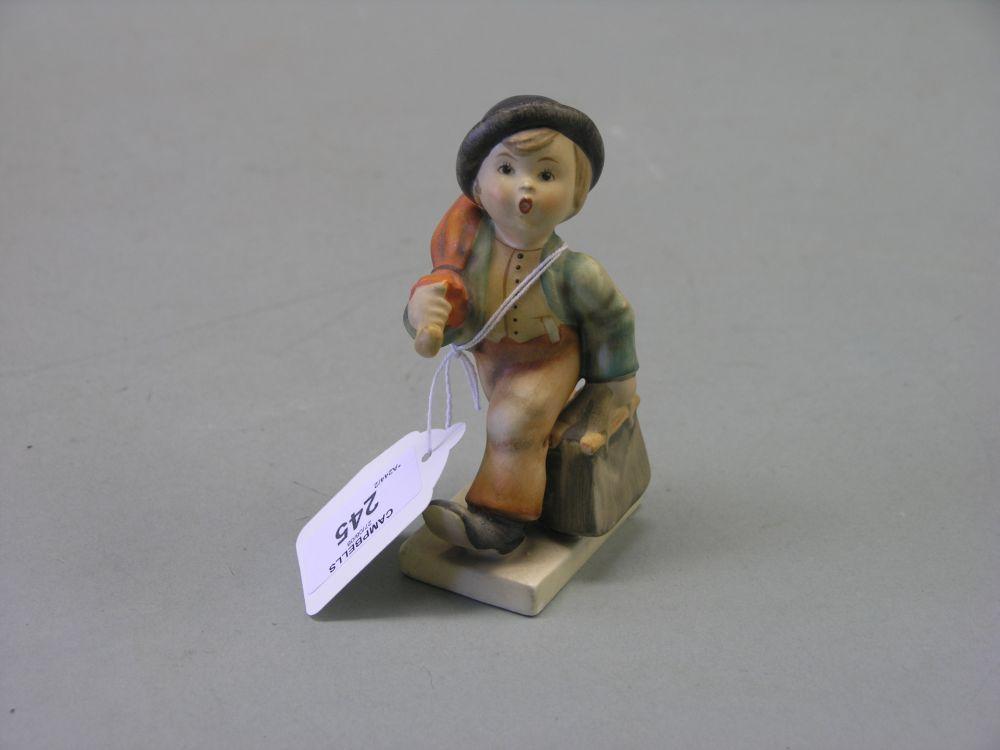 Appraisal: A Goebel-Hummel figure boy carrying umbrella and case in