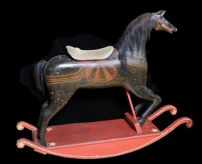 Appraisal: PAINTED WOOD ROCKING HORSE The sponged brown body with suede