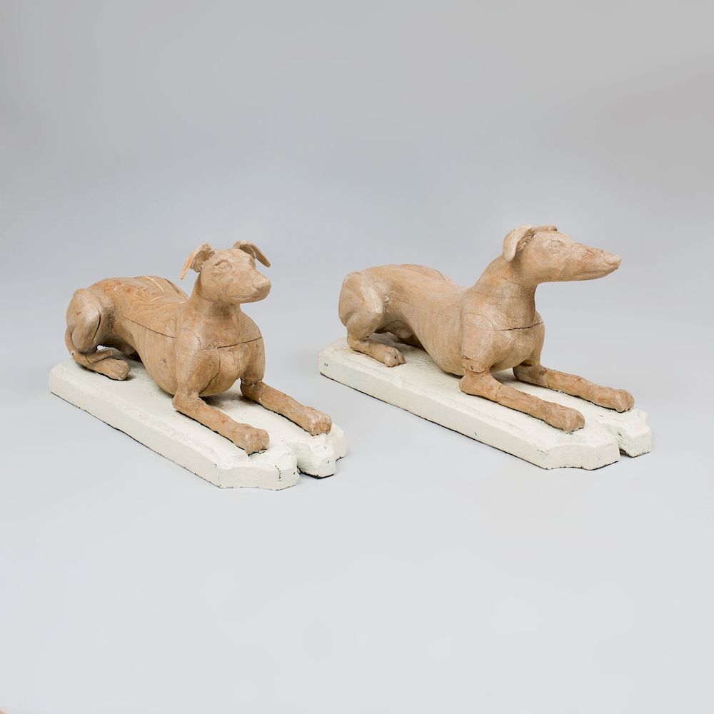 Appraisal: Pair of English Stripped Pine Models of Reclining Whippets Raised