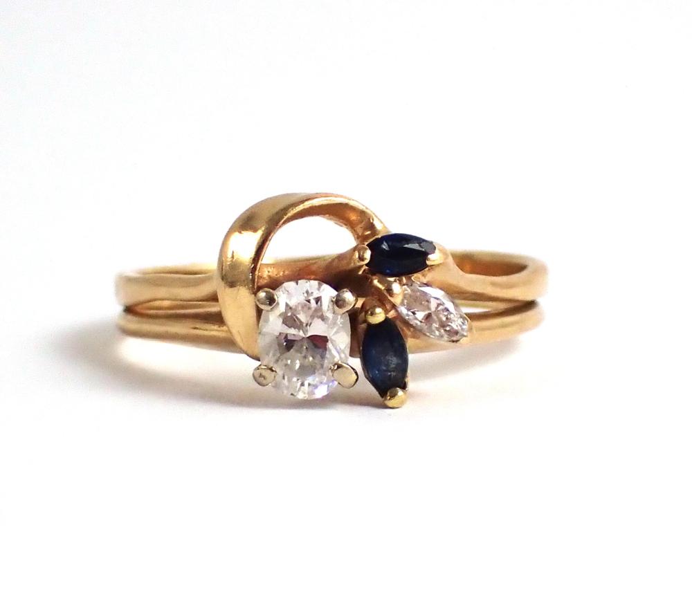 Appraisal: DIAMOND SAPPHIRE AND FOURTEEN KARAT GOLD RING with a marquise-cut