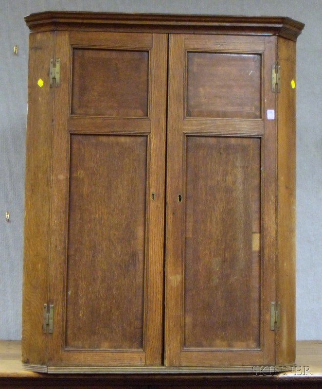 Appraisal: English Oak and Mahogany Crossbanded Two-Door Hanging Corner Cupboard the