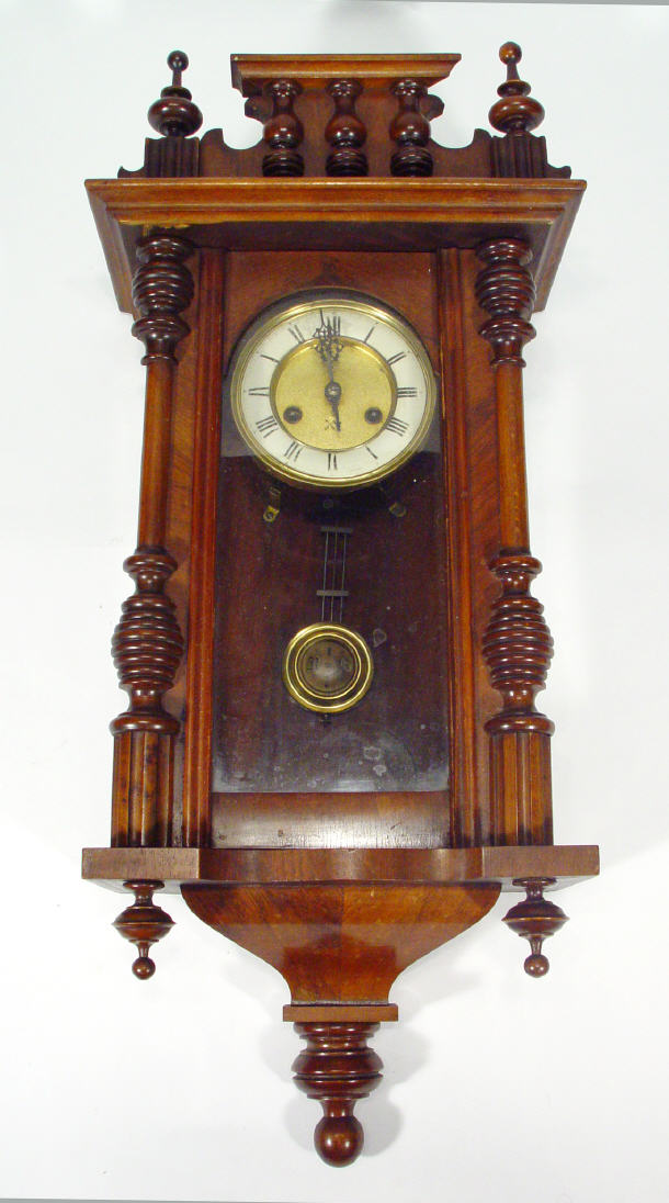 Appraisal: Victorian walnut wall clock with finial pediment above a brass