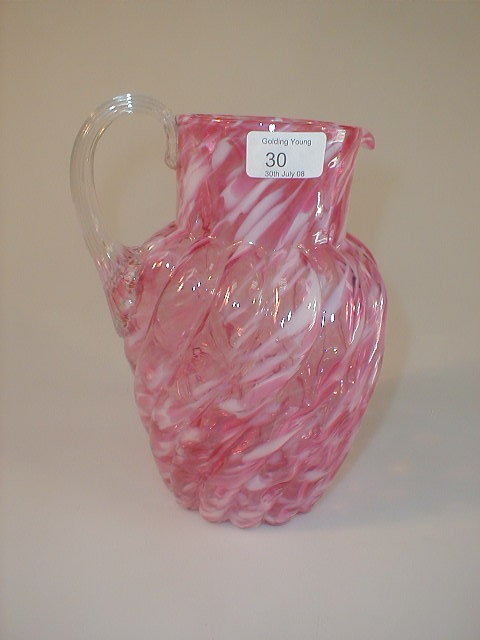 Appraisal: A cranberry glass water jug of wrythen form with a