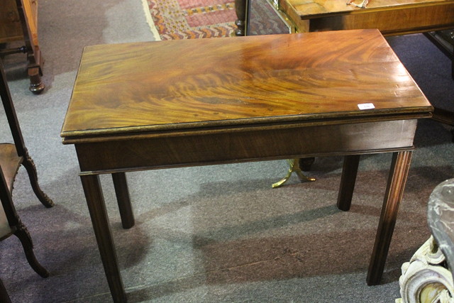 Appraisal: A TH CENTURY MAHOGANY FOLD-OVER TEA TABLE with flame figured