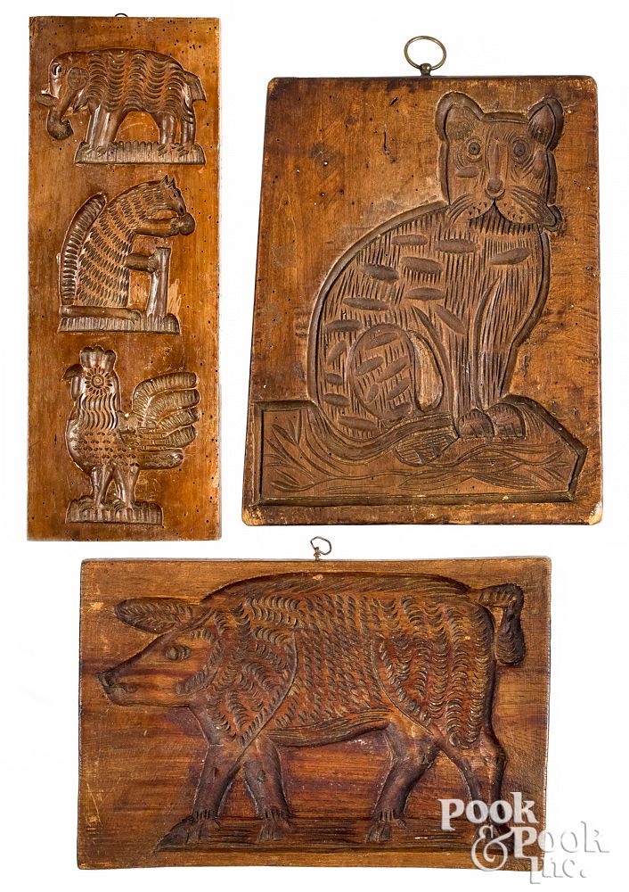 Appraisal: Three carved cakeboards th c to include a cat Three