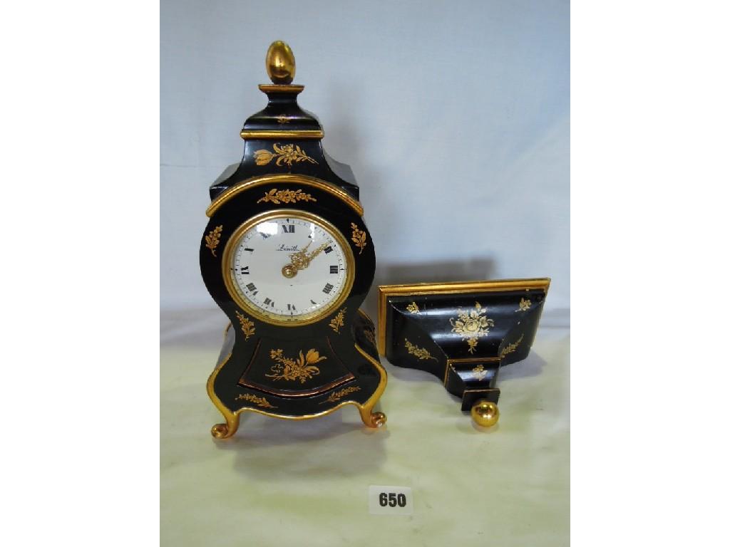 Appraisal: A continental bracket clock with shaped outline gilded floral sprays