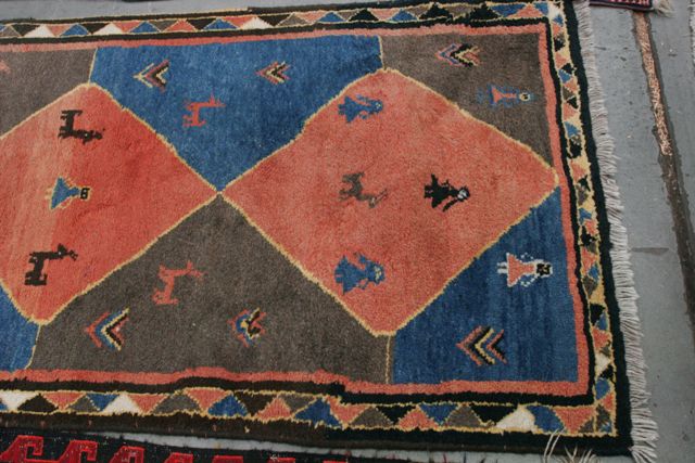 Appraisal: A Ghenji runner with diamond shaped panels decorated with scattered