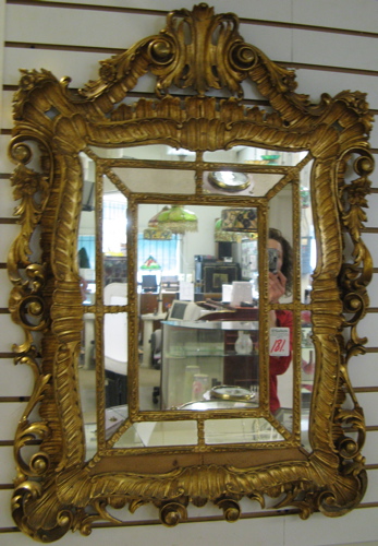 Appraisal: AN ITALIAN CARVED GILT WOOD WALL MIRROR The ornate shell