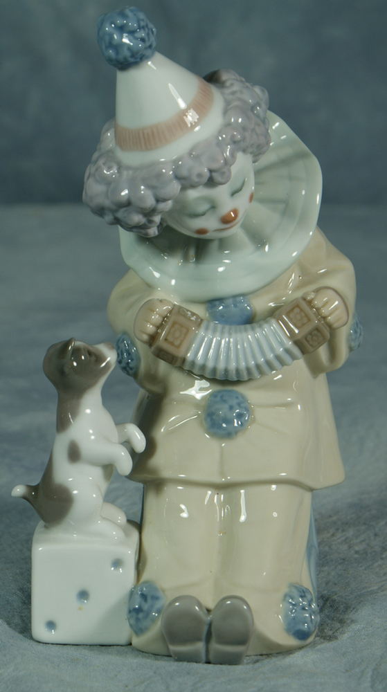 Appraisal: Lladro figurine boy clown with puppy tall no damage Estimate