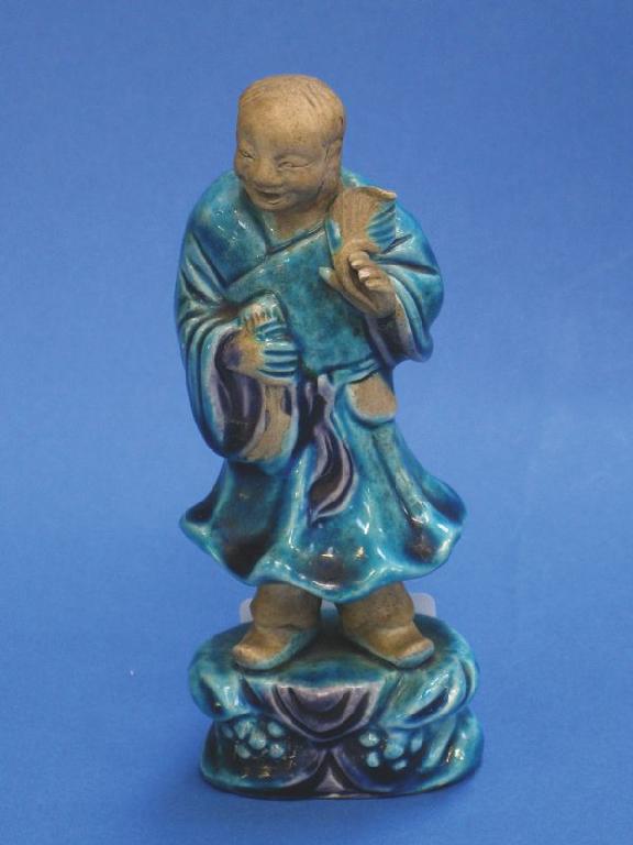 Appraisal: A CHINESE BISCUIT FIGURE of a man partially covered in