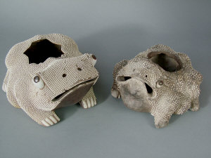 Appraisal: Two Chinese pottery toads the hollow bodies moulded with multiple