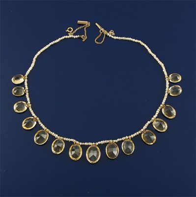 Appraisal: A seed pearl necklace suspending graduated oval shaped citrines