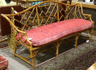 Appraisal: McGuire style rattan settee having an openwork back continuing to