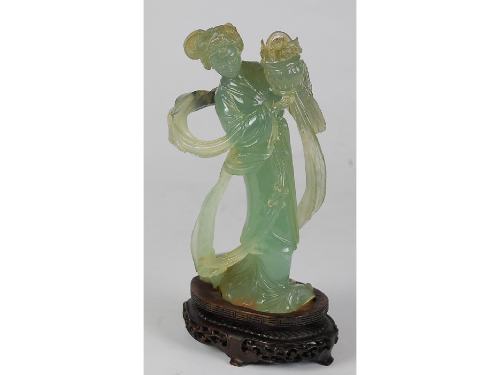 Appraisal: CHINESE CARVED GREEN JADE FIGURE of a lady with flower