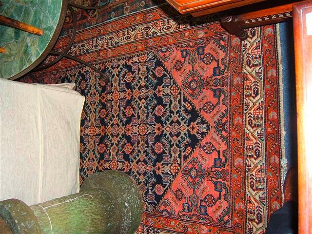 Appraisal: An old dark blue ground Persian rug with stylised designs