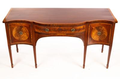 Appraisal: A mahogany serpentine front sideboard crossbanded and fitted two cupboards