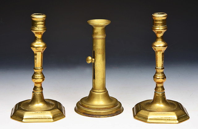 Appraisal: A PAIR OF TH CENTURY BRASS CANDLESTICKS with turned stems