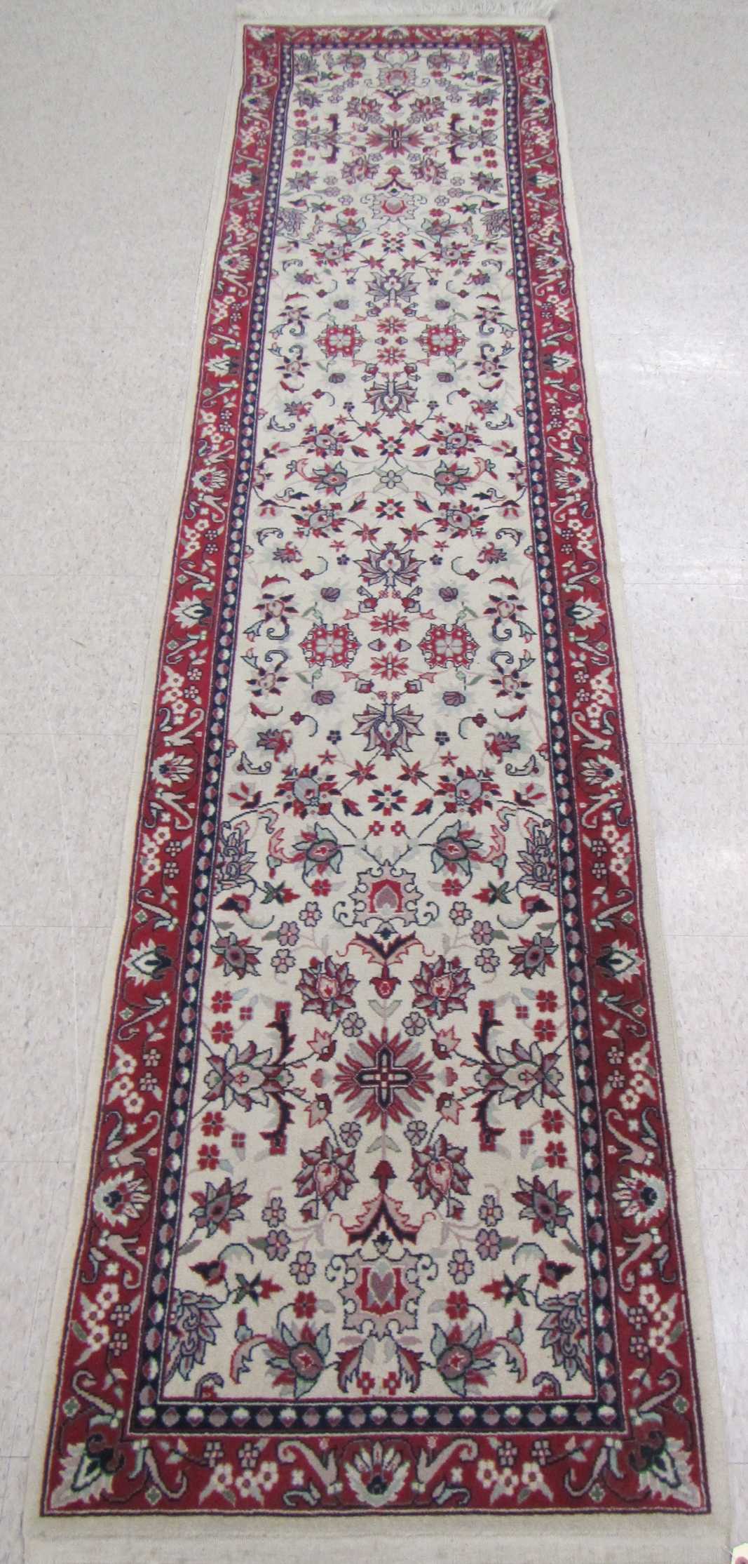 Appraisal: HAND KNOTTED ORIENTAL RUNNER Pakistani-Persian overall floral design on cream