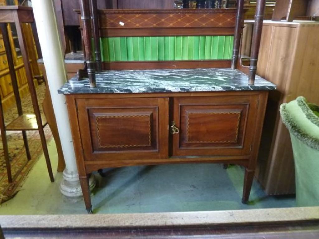 Appraisal: An Edwardian mahogany marble top washstand with tiled splashback and