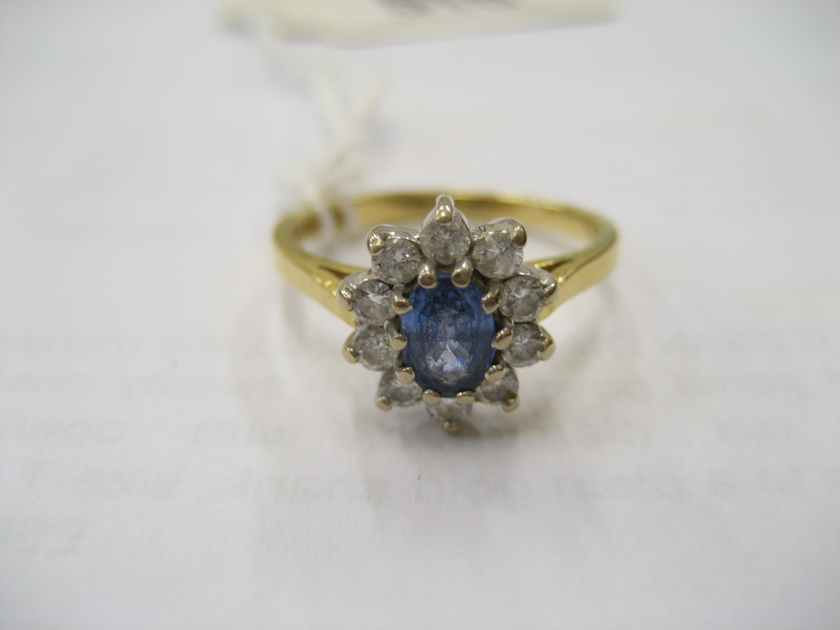 Appraisal: A SAPPHIRE AND DIAMOND CLUSTER RING the oval faceted sapphire