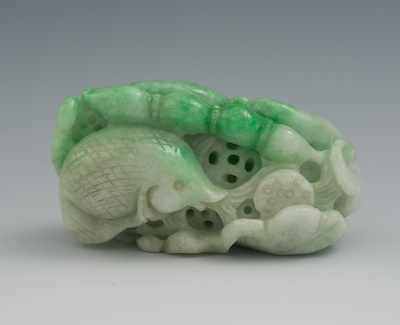 Appraisal: A Chinese Carved Jadeite Ornament Bright green to white jadeite