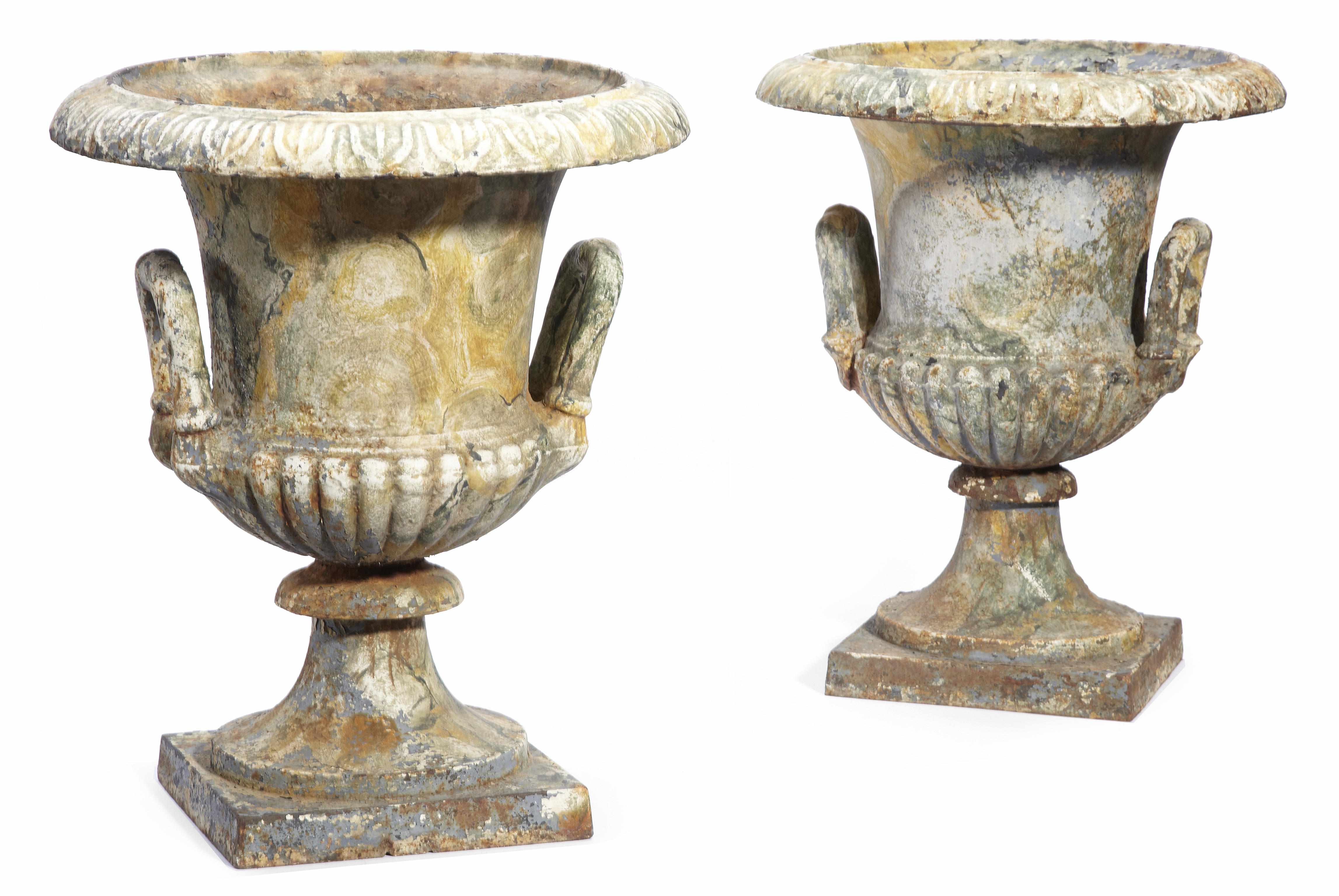 Appraisal: A pair of painted cast iron garden urns of campana