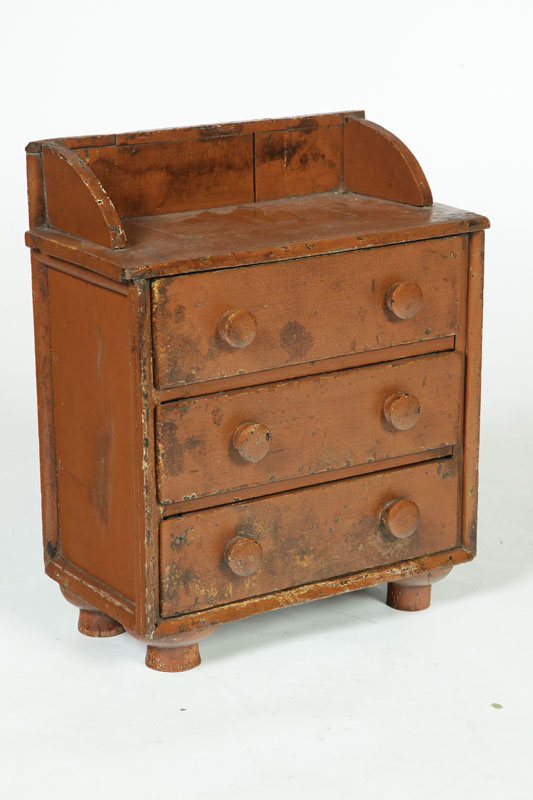 Appraisal: MINIATURE CHEST OF DRAWERS American th century walnut Three drawers