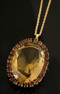 Appraisal: A citrine and smokey quartz pendant Centrally set with an