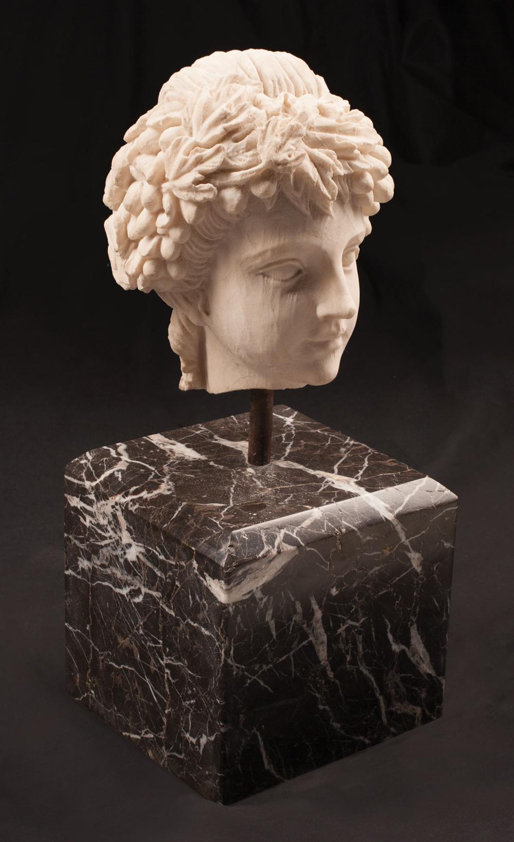 Appraisal: Carved White Marble Head of a Bacchic Youth black marble