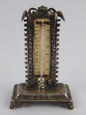 Appraisal: A Georgian silver desk thermometer on four acanthus feet by