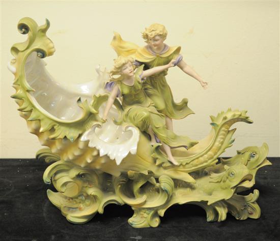 Appraisal: Porcelain figural centerpiece boy and girl figures atop an open