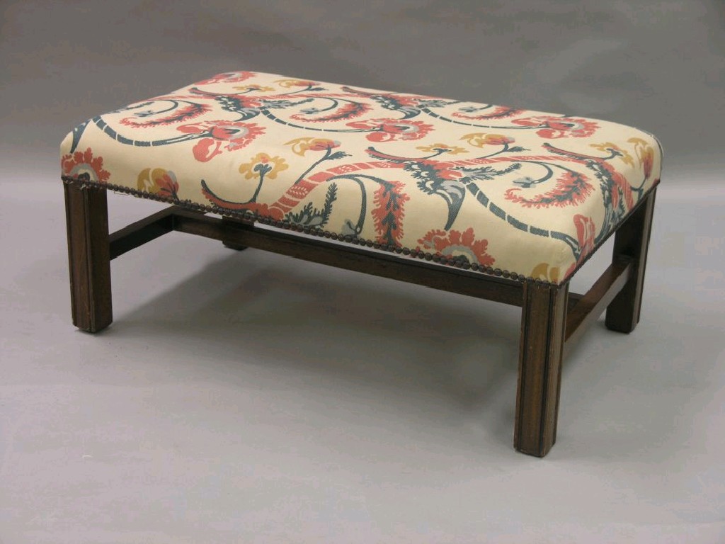 Appraisal: An upholstered footstool bright fabric upon Chippendale-style moulded mahogany legs