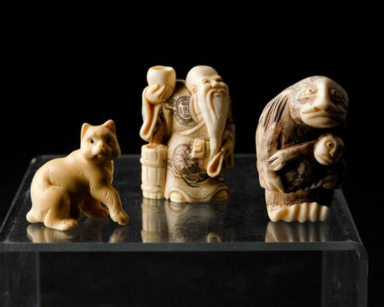 Appraisal: Three Carved Ivory Netsukes a seated cat a monkey with