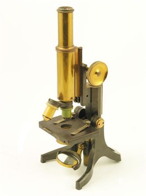 Appraisal: A lacquered brass monocular microscope stamped 'Swift Son Tottenham Ct